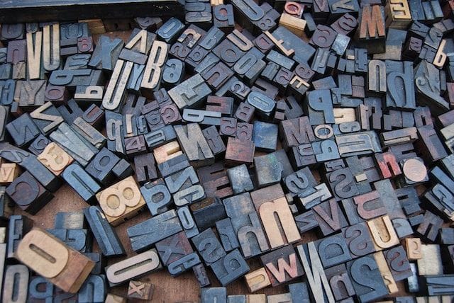 photo of wooden block letters used for type setting