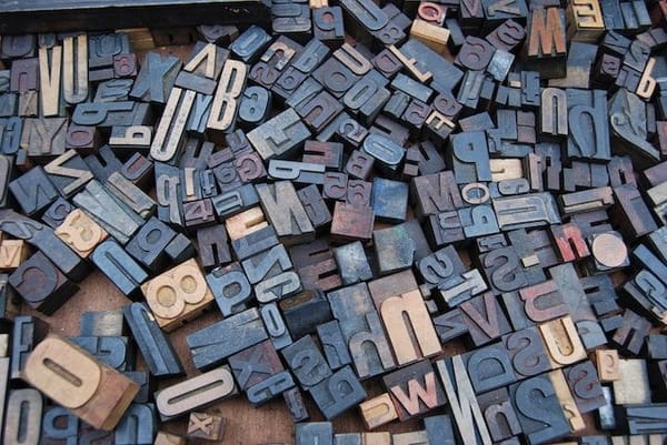photo of wooden block letters used for type setting
