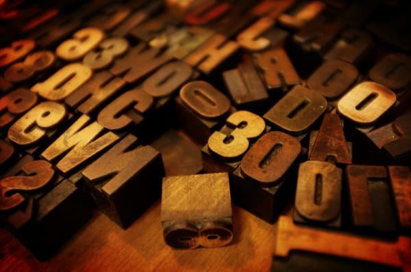 photo of wooden typesetting letters on a table